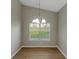 Charming dining area with large window, stylish light and wood floors at 1011 Riverclift Dr, Covington, GA 30016