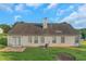 The back of the house features a patio, a grassy yard, and several windows for ample natural light at 1011 Riverclift Dr, Covington, GA 30016