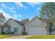 Charming home featuring stone accents, a two-car garage, and blue shutters at 1011 Riverclift Dr, Covington, GA 30016