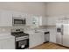 Bright kitchen featuring stainless steel appliances, white cabinets, and quartz countertops at 1011 Riverclift Dr, Covington, GA 30016