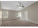 Large main bedroom with neutral tones, ceiling fan, and carpet flooring at 1011 Riverclift Dr, Covington, GA 30016