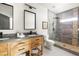 A bathroom features a wood vanity, double sinks, and a large walk-in shower at 1354 Mcpherson Se Ave, Atlanta, GA 30316