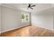 This bedroom offers hardwood floors, a ceiling fan, and large windows for plenty of natural lighting at 1354 Mcpherson Se Ave, Atlanta, GA 30316