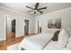This bedroom has hardwood floors, ceiling fan, and doors leading to other rooms at 1354 Mcpherson Se Ave, Atlanta, GA 30316