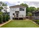 Rear exterior view of a two-story home with a deck, landscaping, and artificial turf at 1354 Mcpherson Se Ave, Atlanta, GA 30316
