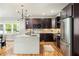 Stylish kitchen featuring a central island, dark wood cabinetry, and stainless steel appliances at 1354 Mcpherson Se Ave, Atlanta, GA 30316