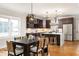 Modern kitchen and dining area with stainless steel appliances, hardwood floors, and custom lighting at 1354 Mcpherson Se Ave, Atlanta, GA 30316
