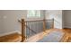 Upper level landing with hardwood floors, decorative railings, and a cozy rug at 1354 Mcpherson Se Ave, Atlanta, GA 30316