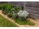 Close up of tasteful landscaping along a wooden fence with decorative rock and river rock at 1354 Mcpherson Se Ave, Atlanta, GA 30316