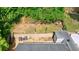 Aerial view of a private backyard with tiered garden beds, a cozy patio, and lush green surroundings at 1915 Cooper Landing Se Dr, Smyrna, GA 30080