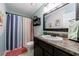Cozy bathroom with updated vanity, framed mirror, and decorative shower curtain at 1915 Cooper Landing Se Dr, Smyrna, GA 30080
