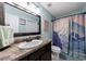 Bathroom showcasing a granite vanity, large mirror, and themed shower curtain at 1915 Cooper Landing Se Dr, Smyrna, GA 30080