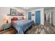 Bright bedroom featuring wood-look flooring, colorful wall art, and blue curtains at 1915 Cooper Landing Se Dr, Smyrna, GA 30080