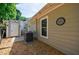 View of a house with tan siding, an air conditioner, and a dart board hanging on the exterior wall at 1915 Cooper Landing Se Dr, Smyrna, GA 30080