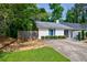 Exterior view of a home with landscaping, fenced yard, and wooded surroundings at 1915 Cooper Landing Se Dr, Smyrna, GA 30080