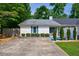 Charming home exterior with manicured landscaping, blue shutters, and fenced-in yard at 1915 Cooper Landing Se Dr, Smyrna, GA 30080