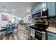 Open kitchen layout with stainless steel appliances and adjacent dining area at 1915 Cooper Landing Se Dr, Smyrna, GA 30080