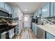 Bright kitchen with blue cabinetry, stainless steel appliances, and stylish mosaic backsplash at 1915 Cooper Landing Se Dr, Smyrna, GA 30080