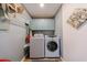 Functional laundry room featuring a washer, dryer, and ample storage space at 1915 Cooper Landing Se Dr, Smyrna, GA 30080