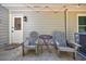 Relaxing patio area with two chairs, a table, a doormat, hanging lights and an air conditioner at 1915 Cooper Landing Se Dr, Smyrna, GA 30080