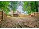 Spacious backyard with wood fencing, mature trees, and a multi-tiered landscape at 4495 Riders Ridge Trl, Snellville, GA 30039