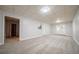 Spacious finished basement has neutral carpet, with a door to the backyard and access to other rooms at 4495 Riders Ridge Trl, Snellville, GA 30039