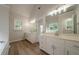 Bright bathroom featuring double sinks, modern fixtures, and a separate water closet for added privacy at 4495 Riders Ridge Trl, Snellville, GA 30039