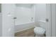 Bathroom featuring a white toilet and a shower with a simple, clean design at 4495 Riders Ridge Trl, Snellville, GA 30039