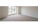 This bedroom has a neutral carpet and large window at 4495 Riders Ridge Trl, Snellville, GA 30039