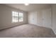 Sunlit bedroom featuring a large window and double closets, offering ample space and storage at 4495 Riders Ridge Trl, Snellville, GA 30039