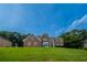 Beautiful brick two-story home with a well-manicured lawn and mature trees at 4495 Riders Ridge Trl, Snellville, GA 30039