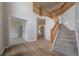Bright foyer with wood floors, carpeted staircase and railing, and neutral walls at 4495 Riders Ridge Trl, Snellville, GA 30039