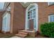 Close-up of a brick home's front entrance with a grand arched window above the door at 4495 Riders Ridge Trl, Snellville, GA 30039