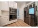 Kitchen with stainless steel appliances, quartz countertop and modern white cabinetry at 4495 Riders Ridge Trl, Snellville, GA 30039