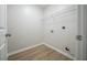 Small but efficient laundry room with wood-look floors and wire shelving ready to be organized at 4495 Riders Ridge Trl, Snellville, GA 30039