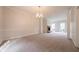 Spacious carpeted living room featuring a classic brick fireplace at 4495 Riders Ridge Trl, Snellville, GA 30039