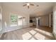 Open living room with wood floors and large windows overlooking a deck at 4495 Riders Ridge Trl, Snellville, GA 30039