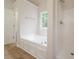 Bright main bathroom with corner jacuzzi tub and separate shower at 4495 Riders Ridge Trl, Snellville, GA 30039