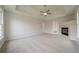 A tray ceiling with fan enhances this spacious main bedroom at 4495 Riders Ridge Trl, Snellville, GA 30039