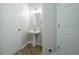 Clean, bright powder room with pedestal sink and modern fixtures at 4495 Riders Ridge Trl, Snellville, GA 30039