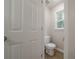 Neat powder room with white toilet and a window that provides a view of the outdoors at 4495 Riders Ridge Trl, Snellville, GA 30039