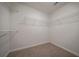 Empty walk-in closet with shelving installed, ready for storage needs at 4495 Riders Ridge Trl, Snellville, GA 30039