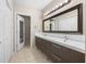 Modern bathroom with double sink vanity, large mirror, and tile flooring, providing a spacious and functional design at 472 Sherman Way, Decatur, GA 30033