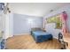 Cozy bedroom featuring wood laminate flooring, a comfortable bed, and a sunny window offering a tranquil space at 472 Sherman Way, Decatur, GA 30033