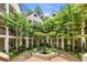 Landscaped courtyard with fountain, trees, and condo buildings surrounding the green space at 472 Sherman Way, Decatur, GA 30033