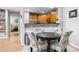 Dining area featuring a table with seating, next to an open kitchen with wood cabinets at 472 Sherman Way, Decatur, GA 30033