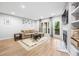 Inviting living room with hardwood floors, a fireplace, and natural light from the balcony at 472 Sherman Way, Decatur, GA 30033
