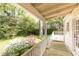 View of the back porch with beautiful flowering plants and wooded backyard at 70 Mount Paran Ne Rd, Atlanta, GA 30342