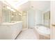 Bright bathroom featuring a large soaking tub, walk-in shower, and skylight for natural light at 70 Mount Paran Ne Rd, Atlanta, GA 30342