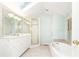 Bathroom featuring a large soaking tub, walk-in shower, and skylight for natural light at 70 Mount Paran Ne Rd, Atlanta, GA 30342